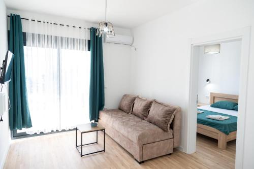 a living room with a couch and a bed at Odore di mare in Ulcinj