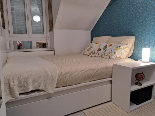 une petite chambre avec un lit et une fenêtre dans l'établissement Petit Appartement Nantais, à Nantes