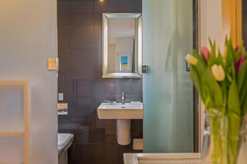 a bathroom with a sink and a mirror at House 36 in Looe