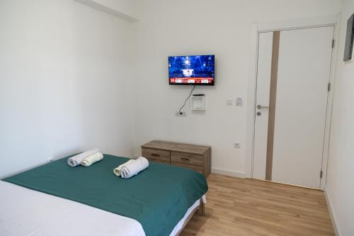 a bedroom with a bed and a flat screen tv at Odore di mare in Ulcinj