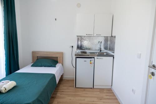 a small bedroom with a bed and a sink at Odore di mare in Ulcinj