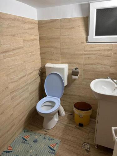 a bathroom with a toilet and a sink at Yellow House in Eforie Nord