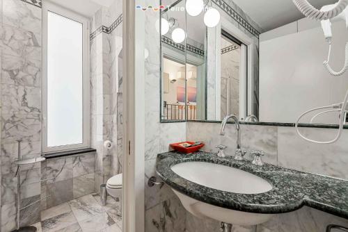 ein Badezimmer mit Waschbecken, Toilette und Spiegel in der Unterkunft La Casa delle Volte, Terre Marine in La Spezia