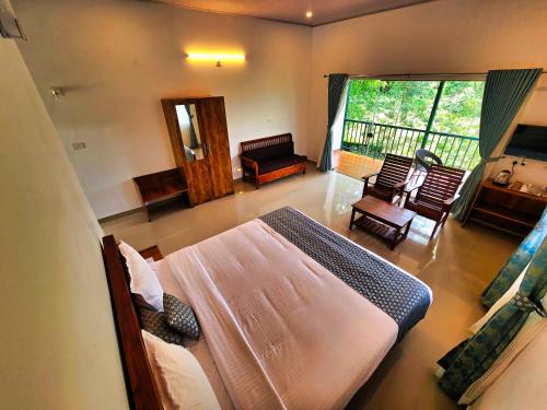 a bedroom with a bed and a living room at BOB Green House in Sultan Bathery