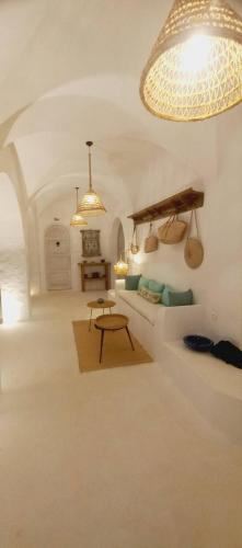 a living room with a couch and a table at Villa Kenzy Djerba in Houmt Souk