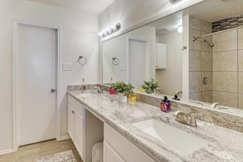 a bathroom with a sink and a large mirror at Home 4 Mi to ATandT Stadium Bring Your Pets! in Arlington
