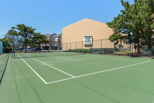 a tennis court in front of a building at Quite Right in Nags Head
