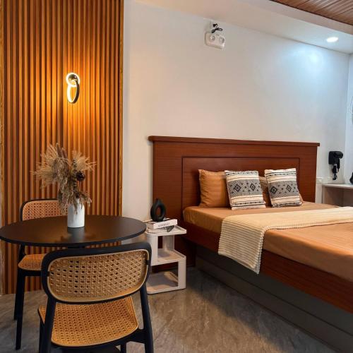 a bedroom with a bed and a table and chairs at CASA KM Beach Pool Access in Dauis