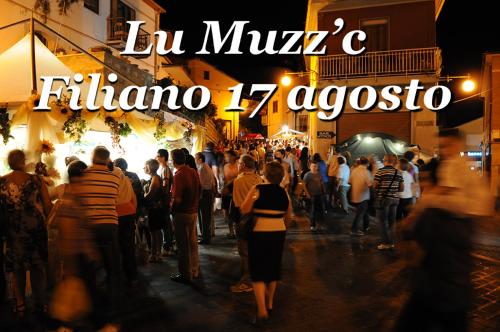 a crowd of people walking down a street at night at Il Piazzale B&B in Filiano