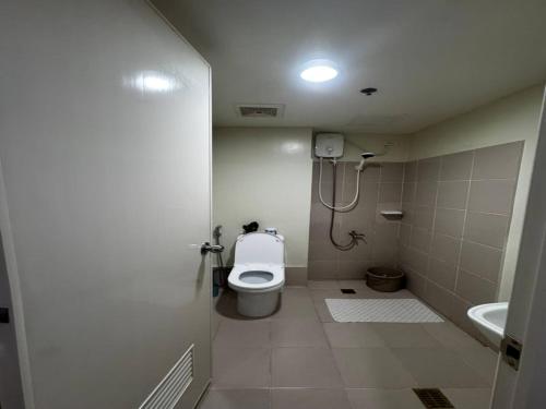 a small bathroom with a toilet and a sink at Cozy Brenthill Condo in Baguio City - Entire House Rental in Baguio