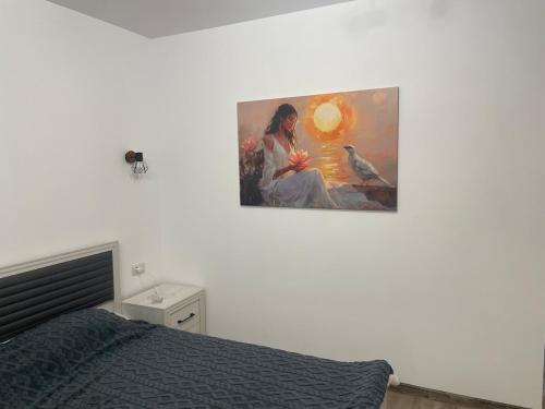 a painting of a woman with a bird on a wall at Răsărit la epava in Costinesti