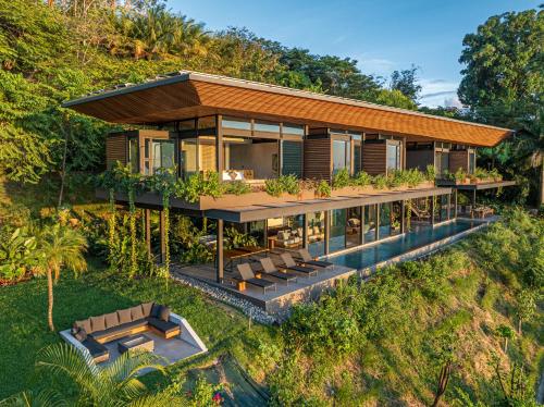 an aerial view of a house with a pool at Amazing View-25m75ft Pool-sleep 16-luxury-private in Dominical