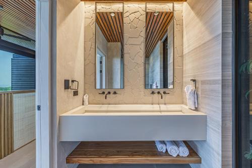 a bathroom with a large white tub and a mirror at Amazing View-25m75ft Pool-sleep 16-luxury-private in Dominical