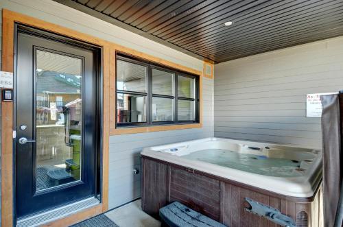 a bath tub in a room with a window at L'Express in Saint-Férréol-les-Neiges