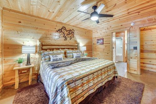 a bedroom with a bed and a ceiling fan at Hot Tub and Game Room Family Retreat in Broken Bow in Broken Bow