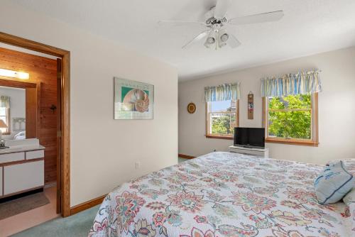 a bedroom with a bed and a ceiling fan at RoSea Retreat in Nags Head