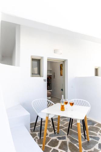 a white table and chairs in a room at Depis castle in Naxos Chora