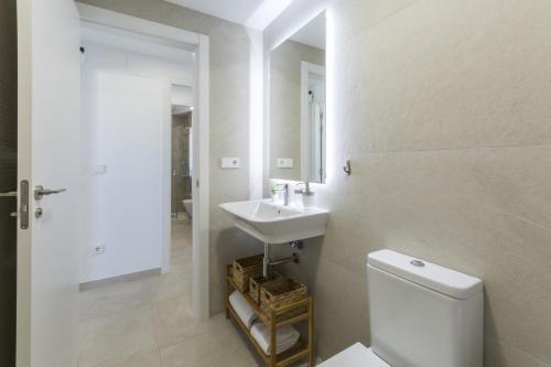 a white bathroom with a sink and a toilet at AG El Alamo in Playa de Gandia