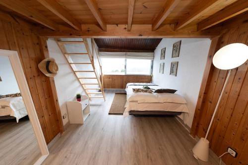 a bedroom with a bed and a staircase in a room at Apartamento El Mirador in Laredo