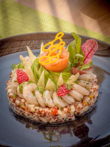 a plate of food with shrimp and vegetables on it at Grand Mogador Agdal & Spa in Marrakech