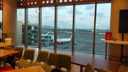 a restaurant with a view of an airport runway at international hoste in Muscat