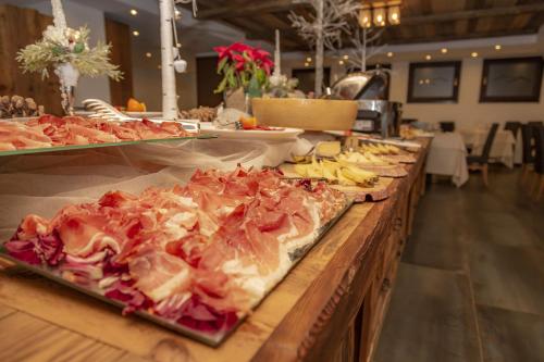 a buffet line with many different types of food at Hotiday Sestriere Ski Run in Sestriere