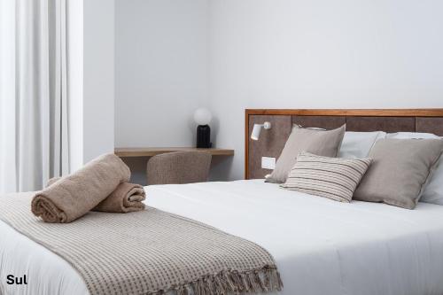 Ένα ή περισσότερα κρεβάτια σε δωμάτιο στο Mónaco Suites & Garden