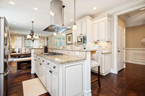 a kitchen with white cabinets and a kitchen island at Salty Crab by Oak Island Accommodations in Oak Island