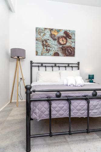 a bed in a room with a picture on the wall at Depis castle in Naxos Chora