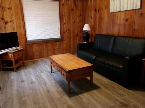 a living room with a couch and a coffee table at Seahorse Oceanfront Lodge in Lincoln City