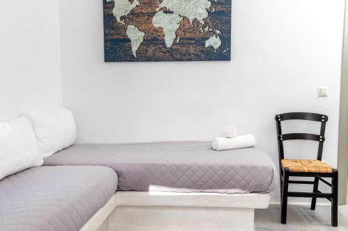 a room with a bed and a chair and a map on the wall at Depis castle in Naxos Chora