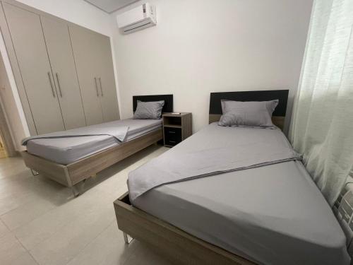 two beds in a room with two beds sidx sidx sidx sidx at Summer Stay in Nabeul