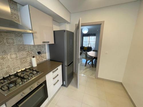a kitchen with a refrigerator and a stove top oven at Summer Stay in Nabeul