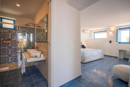 1 dormitorio y baño con ducha. en Borgo del Cannitello Romantic Boutique Resort, en Vulcano