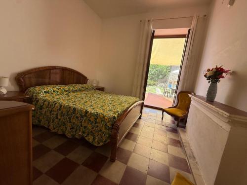 a bedroom with a bed and a window at Casa Vacanze " 'A Chiazza" in Marina di Casalvelino