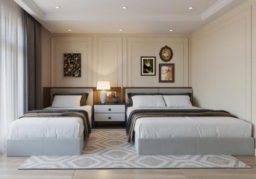 a bedroom with two beds and a table at Euphoria Hotel & Spa in Hanoi