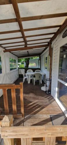 a wooden deck with a table and chairs on it at MOBIL HOME in Ivry-la-Bataille