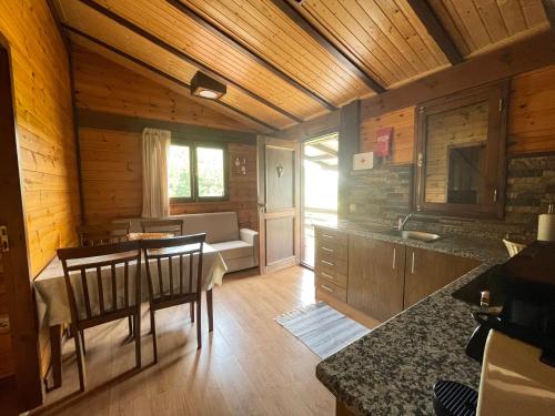 a kitchen and dining room with a table and a couch at Casa do Casal in Arouca