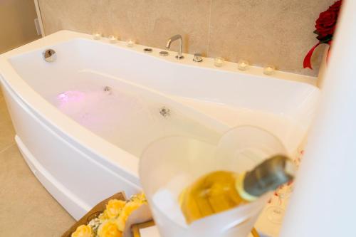 a white bath tub with a bottle in it at Partenope's House in Ercolano
