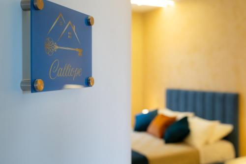 a blue sign in a room with a couch at Partenope's House in Ercolano