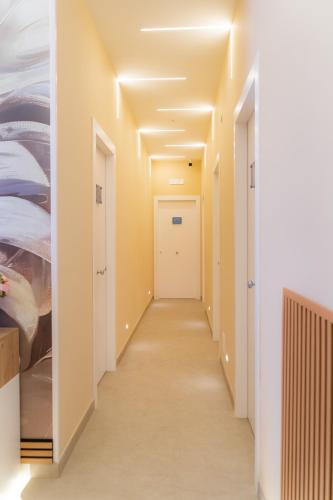a hallway with white walls and a white door at Partenope's House in Ercolano