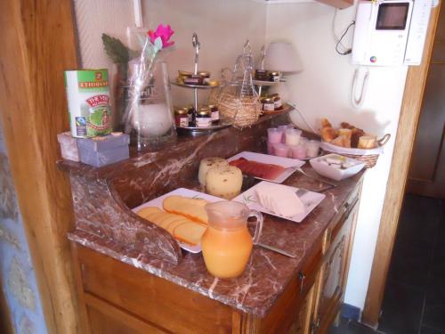 a counter with food and a jug of orange juice at B&B Nord Sud in Salmchâteau