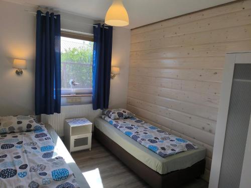 En eller flere senge i et værelse på Domki U Marty - Domek Grażyna