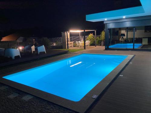 a swimming pool in front of a house at night at CASA TAPADA DA CHEDA 2 in Celorico de Basto
