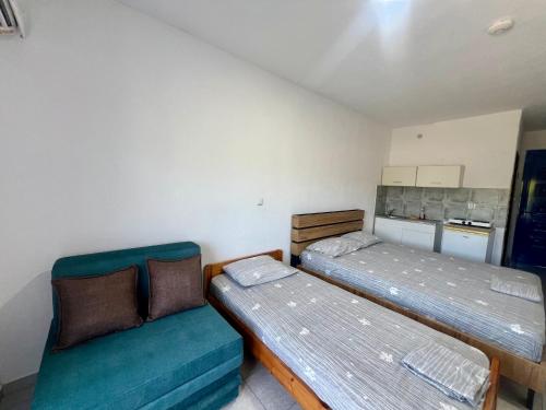 a small room with two beds and a couch at Salt & Sea in Sarti