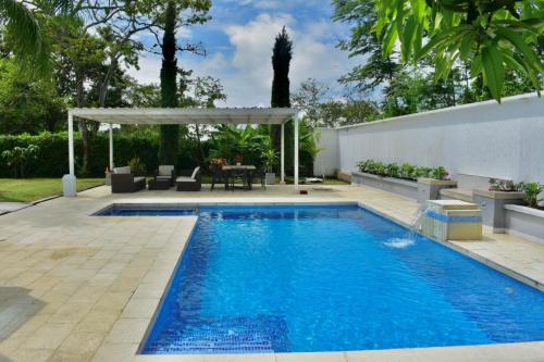 una piscina in un cortile con pergolato di Luxurious Country House a Pereira