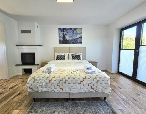 a white bedroom with a bed and a television at Klimatyczny Dom na Mazurach przy jeziorze in Sędańsk