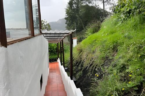 a walkway leading up to a building with a window at La casa del cielo in Subachoque