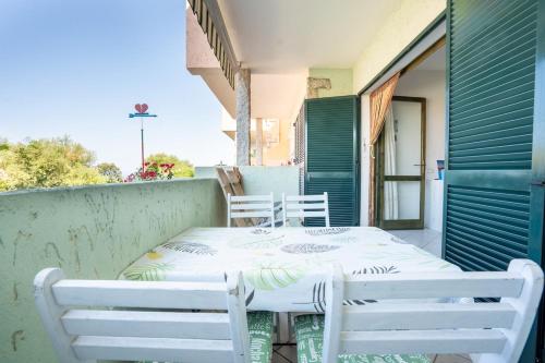 a table and chairs on the balcony of a house at Sea View House on the Gulf of Asinara in Badesi