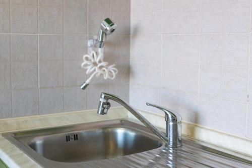 a sink with a faucet in a kitchen at Sea View House on the Gulf of Asinara in Badesi